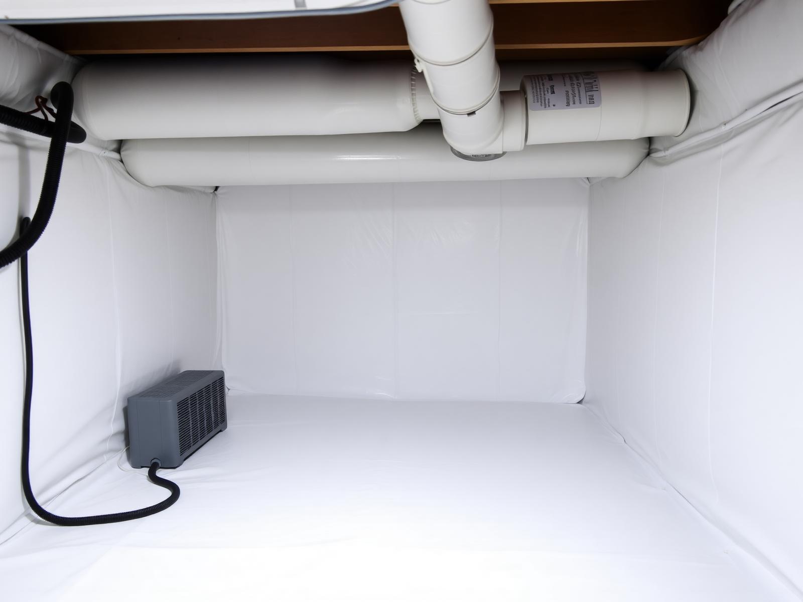 Clean encapsulated residential crawl space with a heavy white vapor barrier and dehumidifier